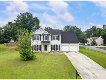 Charming two-story home featuring a well-manicured lawn and a two-car garage at 2833 Golden Club Bnd, Austell, GA 30106