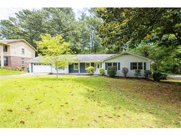 Charming single-story home with a well-manicured lawn and mature trees enhancing curb appeal at 2519 Lauderdale Ne Dr, Atlanta, GA 30345