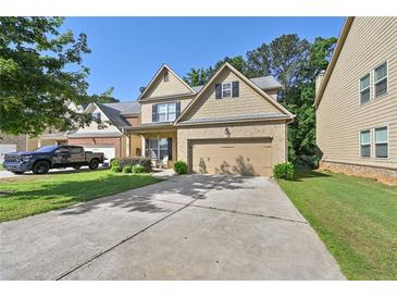 Charming two-story home with a brick front, inviting entrance, and a two car garage at 2550 Trelipe Dr, Lawrenceville, GA 30044