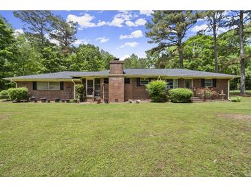 Charming brick home featuring a classic design and a lush, green front yard at 3630 Spot Rd, Cumming, GA 30040
