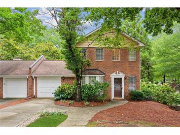 Charming brick home with lush landscaping and a welcoming front entrance surrounded by mature trees at 101 Swanton Hill Ct, Decatur, GA 30030