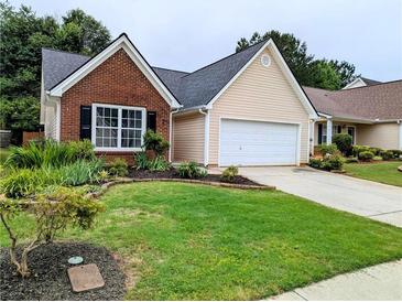 Charming single-Gathering home with brick and siding and a well-manicured front yard at 225 Kentshire Pl, Lawrenceville, GA 30044