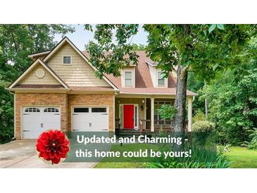 Charming two-story home featuring a combination of stone and siding, complemented by a bright red front door at 36 Laurel Ne Way, White, GA 30184