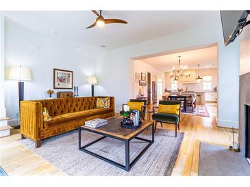 Inviting living room featuring hardwood floors, a stylish velvet sofa, and an open layout to the kitchen at 2067 Telfair Circle # A&B, Atlanta, GA 30324