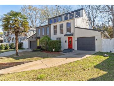 Modern two-story home with colorful doors, brick facade, garage, and well-manicured lawn at 549 Ne Parkway Ne Dr, Atlanta, GA 30308