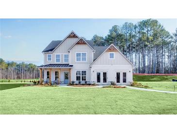 Beautiful two-story home with a large, well-manicured lawn and appealing architectural details at 272 Rockledge Sw Bnd, Powder Springs, GA 30127