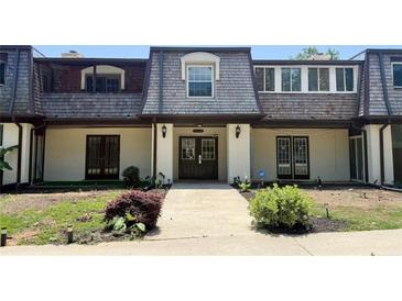 Charming townhome with a symmetrical design and well-maintained landscaping at 125 Rue Fontaine, Lithonia, GA 30038