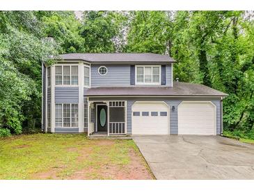 Charming two-story home featuring a two-car garage and inviting front porch at 5352 Windfern Ct, Stone Mountain, GA 30088