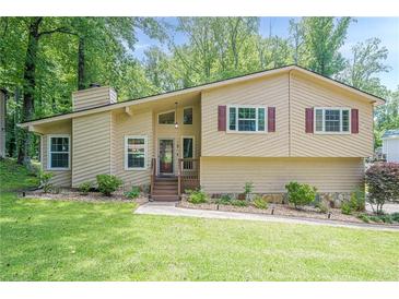 Charming home featuring a well-manicured lawn, neutral siding, and updated windows at 1137 Poplar Log Pl, Austell, GA 30168