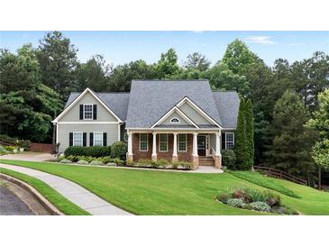 Charming home with stone accents, a well-manicured lawn, and lush landscaping provides great curb appeal at 12 Isabella Ne Ct, Cartersville, GA 30121