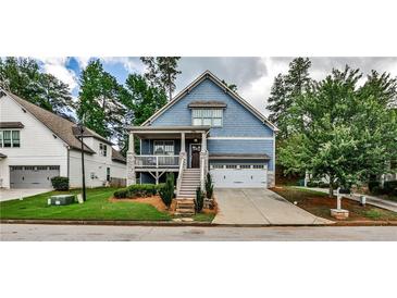 Charming two-story blue home with a welcoming front porch and manicured landscaping at 2956 Silver Hill Se Ter, Atlanta, GA 30316
