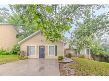 Charming single-story home with neutral siding, a well-manicured lawn, and a welcoming front entrance at 5888 Old Wellborn Trce, Lithonia, GA 30058