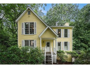 Charming yellow two-story home with white trim and mature landscaping at 1879 Beaver Dam Ne Ln, Marietta, GA 30062