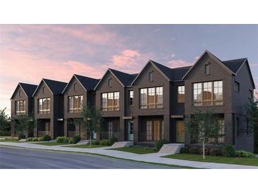 Charming new townhomes with brick facade, large windows, and professional landscaping on a tree-lined street at 1348 Grannysmith Trce # 39, Brookhaven, GA 30319