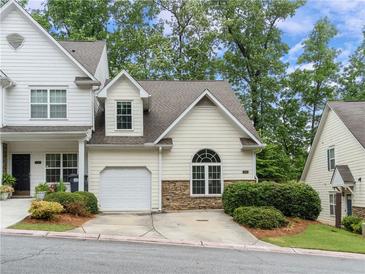 Charming townhome with a one-car garage, stone accents and mature landscaping provides great curb appeal at 412 Mcafee Nw Ct # 14, Kennesaw, GA 30144