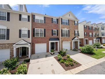 Townhouse exteriors boast brick and siding, with attached garages and manicured landscaping at 3542 Chattahoochee Summit Se Ln, Atlanta, GA 30339