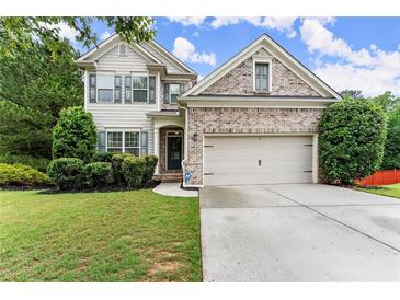 Charming two-story home with a well-manicured lawn and a two-car garage at 6160 Overleaf Ter, Cumming, GA 30040