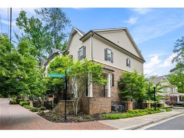 Charming two-story home with brick and siding exterior, lush landscaping, and welcoming front entrance at 148 Canton St, Alpharetta, GA 30009