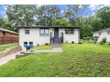 Charming one-story home featuring a well-maintained front yard and inviting entrance at 569 Oakside Sw Dr, Atlanta, GA 30331