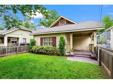Charming single story home with a well manicured lawn, quaint front porch, and picket fence at 176 Ormond Se St, Atlanta, GA 30315