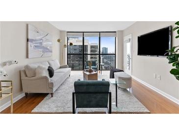 Bright living room features city views, modern decor, and a large window for natural light at 1280 W Peachtree Nw St # 3208, Atlanta, GA 30309