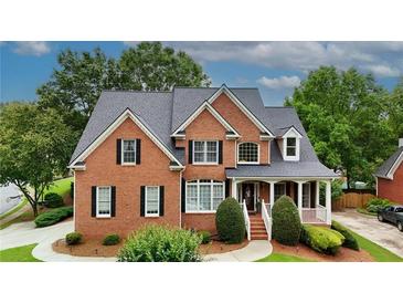 Charming two-story brick home with a well-maintained lawn and mature trees at 793 Fairington Pl, Lawrenceville, GA 30044