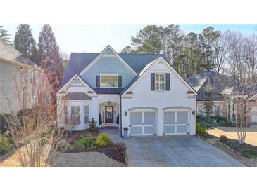 Charming two-story home with a well-maintained front yard, two-car garage and lovely landscaping at 3355 Olivia Ct, Cumming, GA 30041