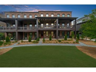 Attractive brick townhomes feature private terraces overlooking a manicured lawn at 6370 Cortland Walk, Alpharetta, GA 30005