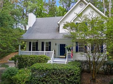 Charming two-story home with a welcoming front porch and lush landscaping at 350 Westchester Way, Canton, GA 30115