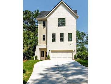 Attractive new construction home featuring a brick facade, two-car garage and manicured lawn at 2745 S Bamby Ne Ln, Brookhaven, GA 30319