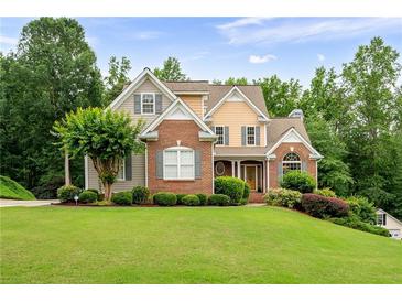 Charming two-story home with brick and siding accents and a well-manicured lawn at 223 Oak Grove Dr, Dallas, GA 30157