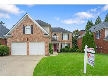 Charming brick home with a well-manicured lawn and a two-car garage at 3032 Montclair Se Cir, Smyrna, GA 30080