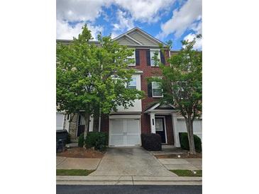 Two story brick townhome with attached garage and beautiful mature trees at 2137 Meadow Peak Rd, Duluth, GA 30097