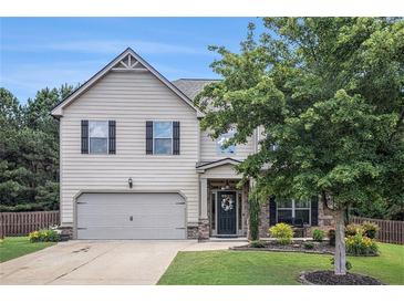 Charming two-story home features a manicured front lawn, attached garage, and inviting curb appeal at 5925 Whitney Ct, Cumming, GA 30041