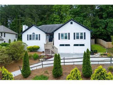 Charming home featuring a two-car garage, front yard landscaping and a welcoming entrance at 2111 Yorkshire Ct, Woodstock, GA 30189