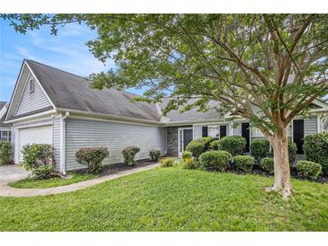 Charming one-story home featuring a well-manicured lawn, neatly trimmed shrubs, and gray siding at 104 Terrapin Ct, Carrollton, GA 30116