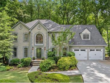 Charming two-story home with a well-manicured lawn, mature trees and a two car garage at 4402 Windsor Oaks Chase, Marietta, GA 30066