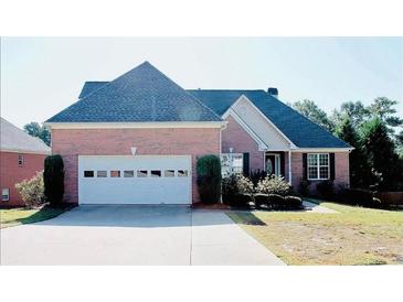 Charming single-story brick home with a two-car garage and beautifully landscaped front yard at 1225 Martin Chapel Ln, Lawrenceville, GA 30045