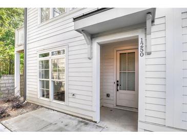 Inviting front entrance of a charming home with a white exterior and classic architectural details at 1250 Oxley Nw Ln, Atlanta, GA 30307