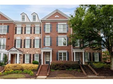 Charming brick townhome with neat landscaping, black shutters, and a welcoming front entrance at 4503 Kendall Way, Roswell, GA 30075