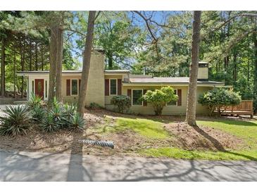Charming single-story home with a well-maintained lawn and mature trees enhancing its curb appeal at 609 Redwood Drive Dr, Woodstock, GA 30189