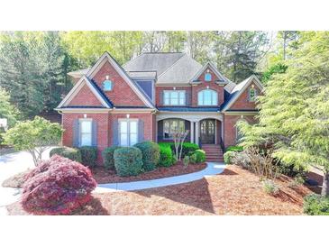 Charming brick home with a well-manicured lawn and inviting front entrance at 10125 Brixton Pl, Suwanee, GA 30024