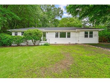 Charming single-story home with a well-maintained lawn and mature trees at 2045 Sherwood Se Dr, Marietta, GA 30067