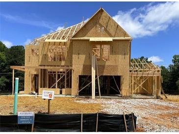 Two-story home under construction featuring wood framing and exposed beams at 675 Crest Line Trl, Powder Springs, GA 30127