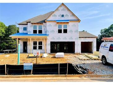 New two-story home under construction with visible framework and materials, showcasing the building process at 675 Crest Line Trl, Powder Springs, GA 30127