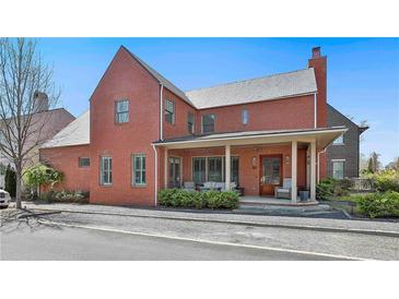Charming two-story brick home featuring a welcoming covered porch with stylish outdoor furniture at 175 Central Ave, Fayetteville, GA 30214