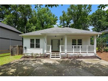 Charming single-story home with a welcoming front porch and manicured landscaping at 1245 Ladd Sw St, Atlanta, GA 30310