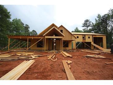 Exterior view of a two-story home under construction, featuring wood framing and a covered porch at 578 Price Rd, Carrollton, GA 30116