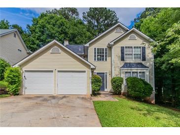 Charming two-story home featuring a two-car garage and well-maintained front yard, perfect for Gathering living at 3732 Landgraf Cv, Decatur, GA 30034