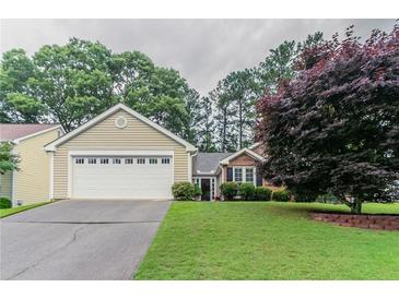 Charming single-Gathering home featuring an attached garage and well-maintained front lawn at 1115 Hunters Creek Ct, Lawrenceville, GA 30043